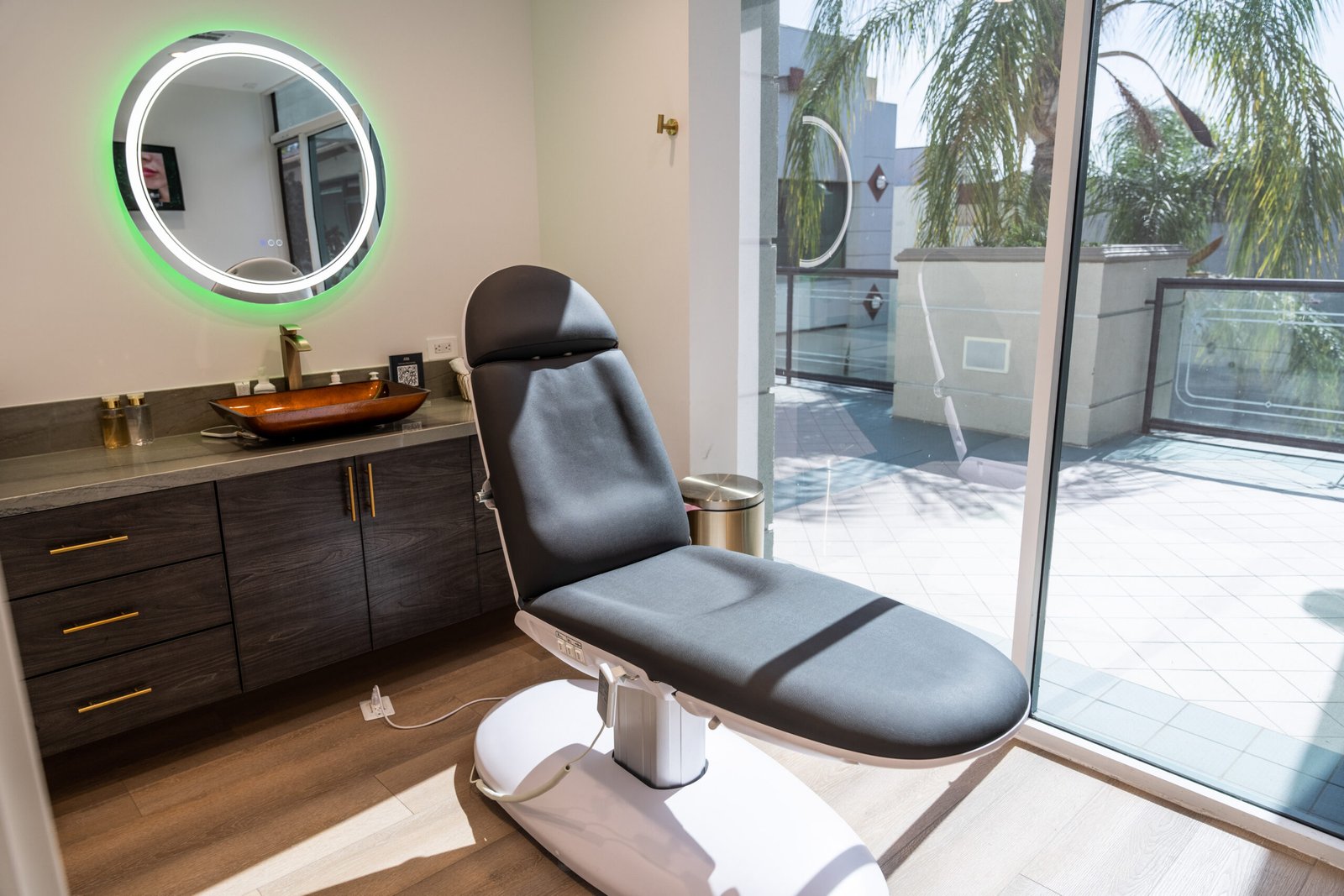 Glow Aesthetic Center treatment room with lighted mirror and vanity